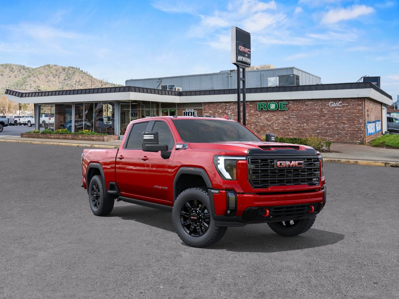2026 GMC Sierra 2500 HD AT4 in Volcanic Red Tintcoat — front three-quarter view