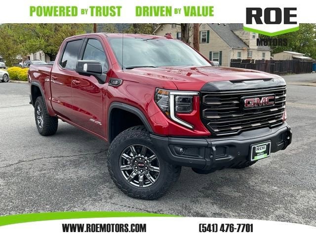 2026 GMC Sierra 1500 AT4X in Volcanic Red Tintcoat — front three-quarter view